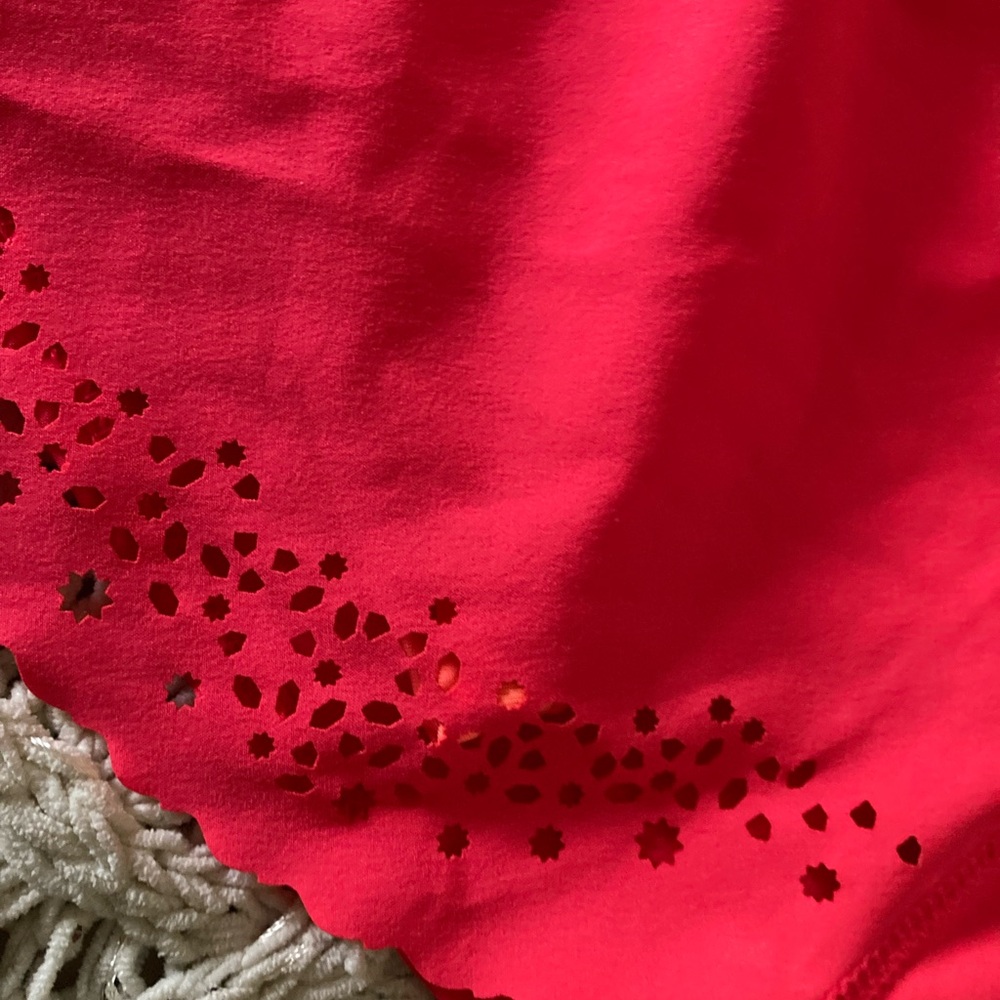 Hind small hot pink athletic skorts with ruffle detail and laser cut detail